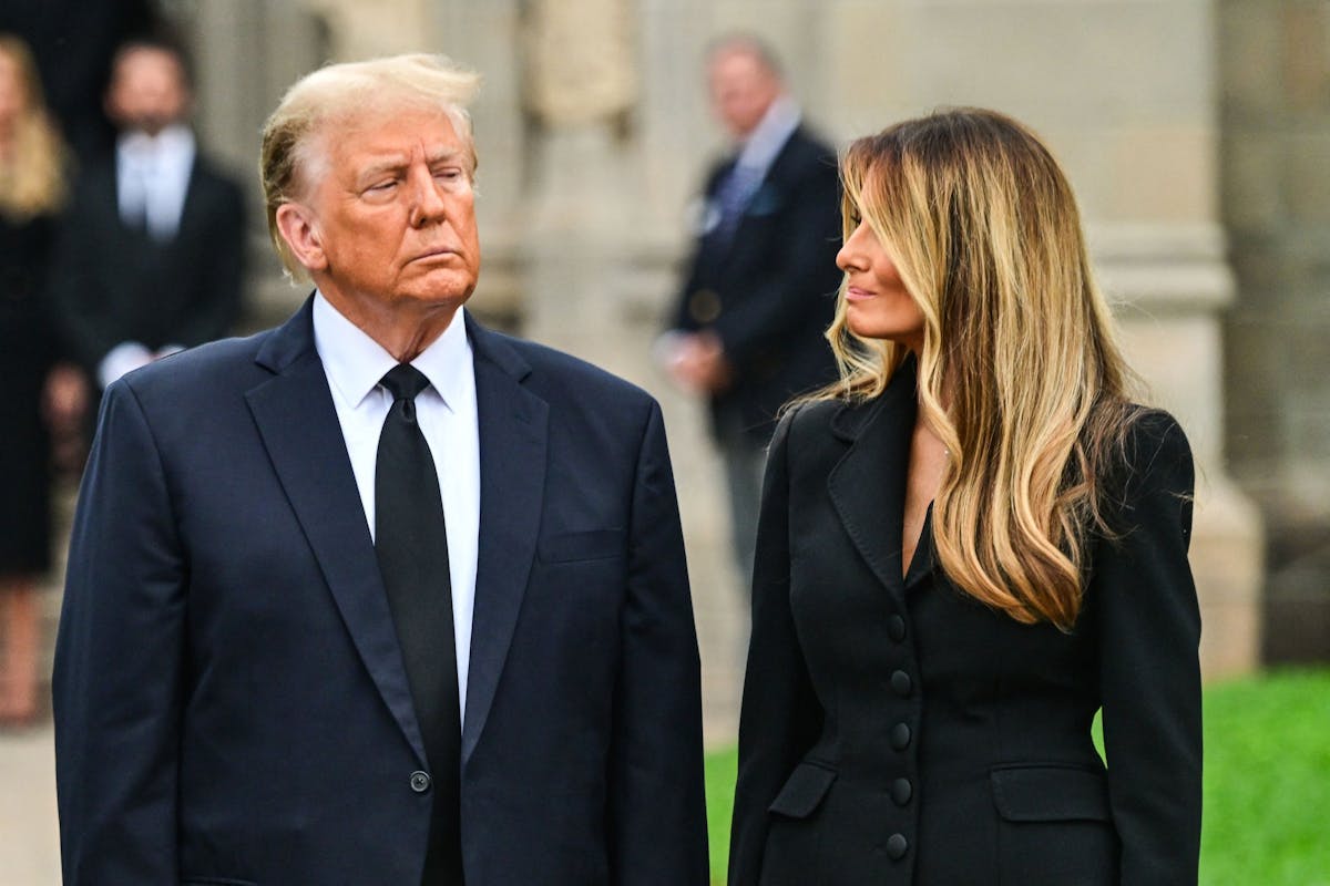 Former US President Donald Trump with his wife at his mother's funeral.
